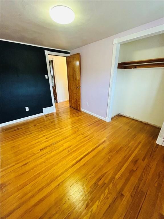 unfurnished bedroom featuring light hardwood / wood-style floors and a closet