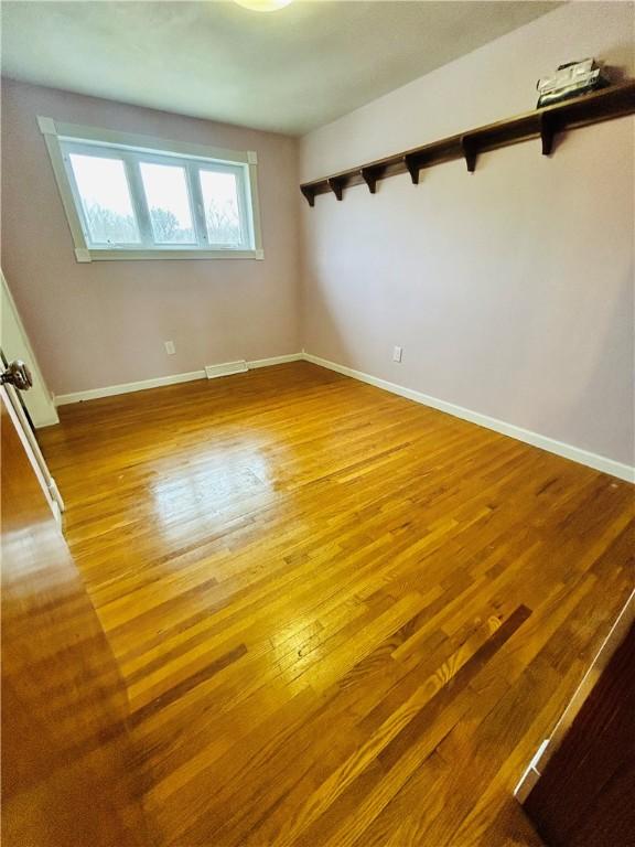 unfurnished room with wood-type flooring