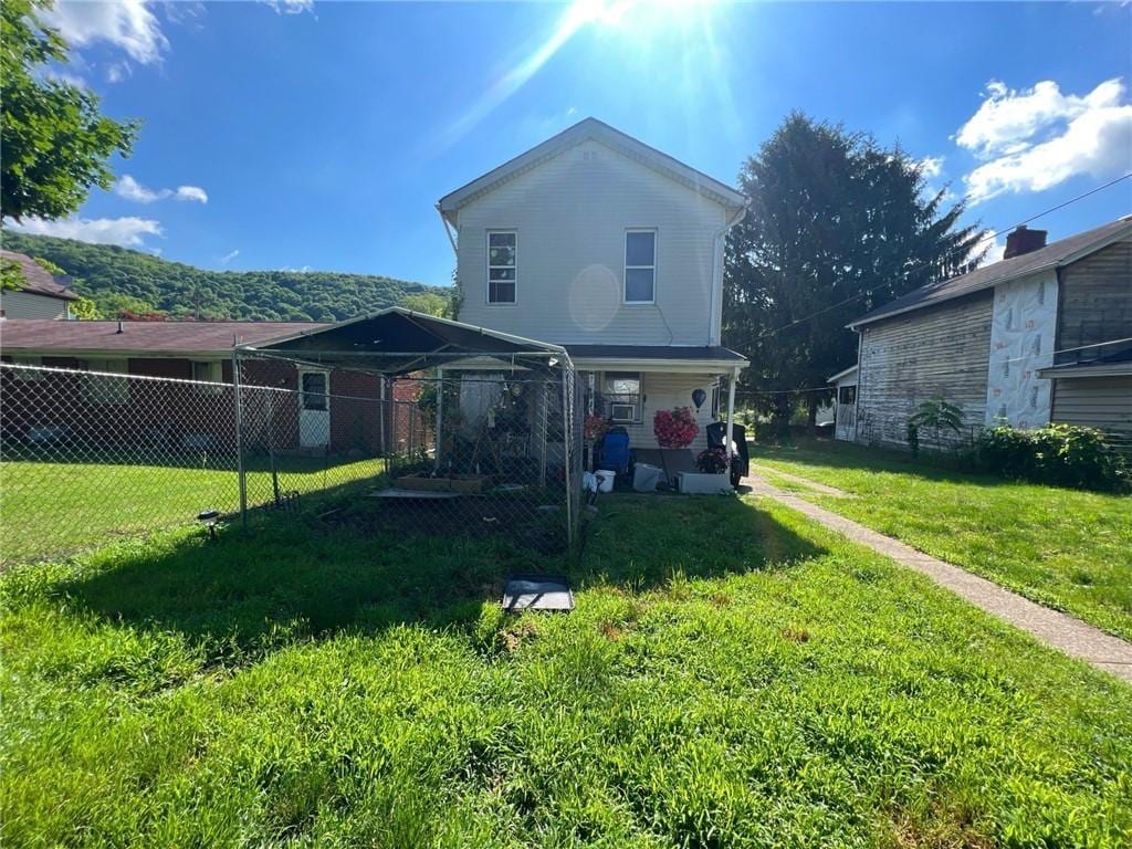 back of property featuring a yard and a gazebo