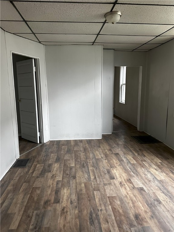 spare room featuring visible vents, a paneled ceiling, and wood finished floors