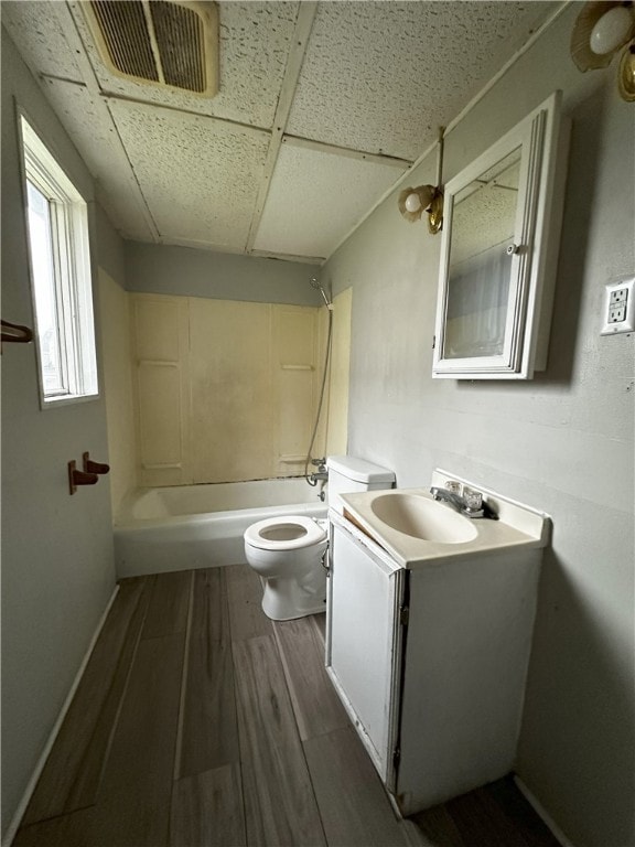 full bathroom featuring visible vents, toilet, wood finished floors, shower / bath combination, and vanity