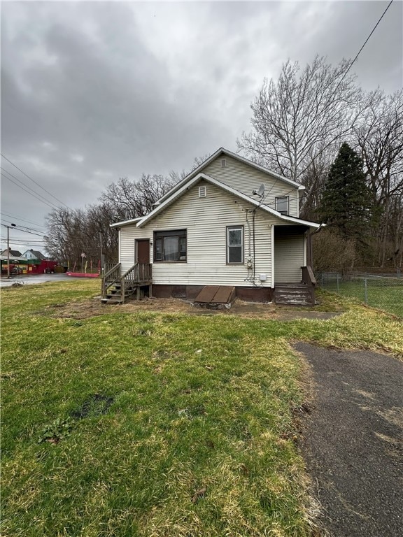 view of front of property with a front yard and fence