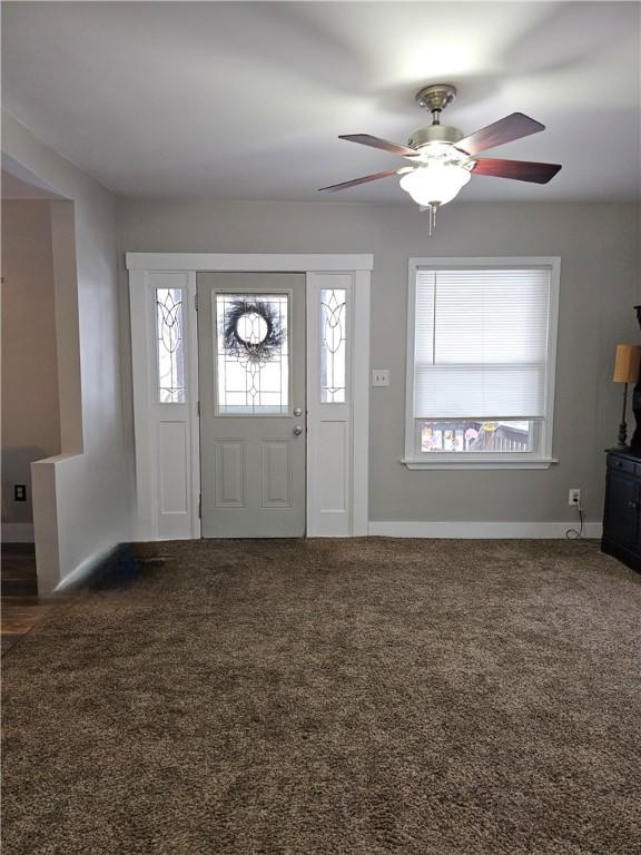 carpeted entryway featuring plenty of natural light and ceiling fan