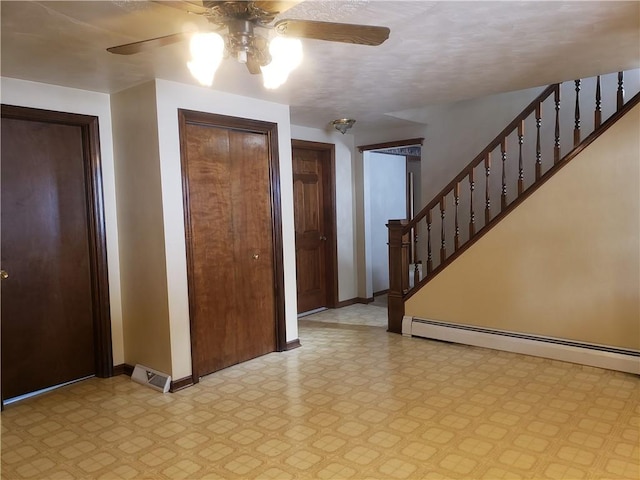 foyer featuring ceiling fan and baseboard heating