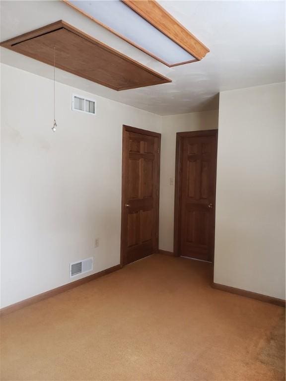 unfurnished room with light colored carpet