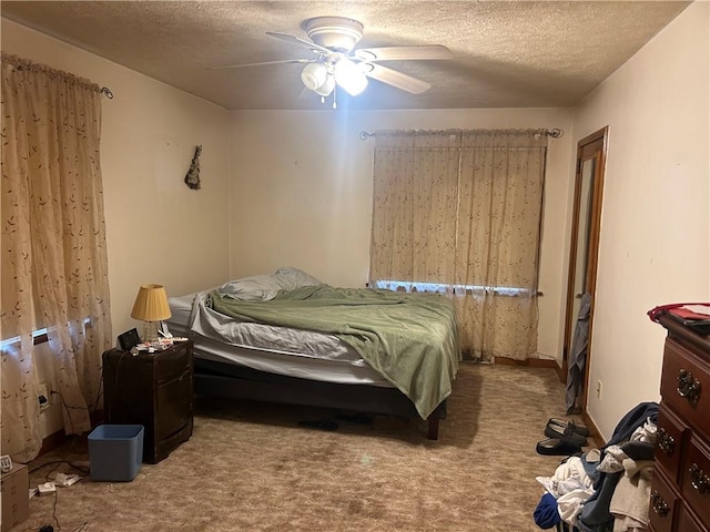 carpeted bedroom with ceiling fan and a textured ceiling