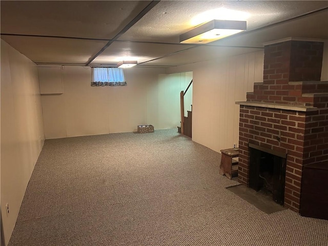 basement featuring carpet flooring and a fireplace