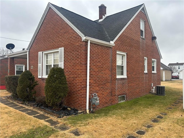 view of home's exterior featuring a yard and central air condition unit