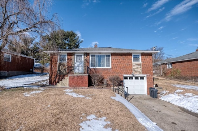 single story home featuring a garage, driveway, and brick siding