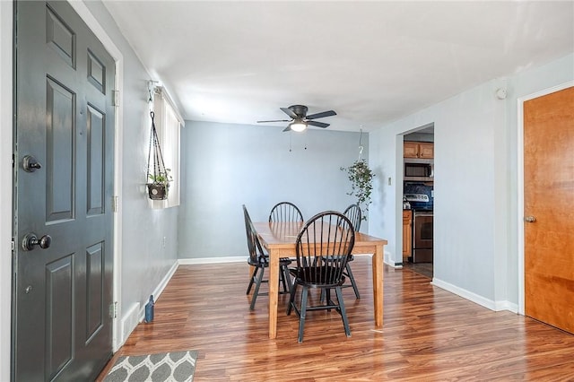 dining area with ceiling fan, baseboards, and wood finished floors