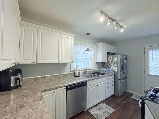 kitchen with stainless steel appliances, decorative light fixtures, and white cabinets