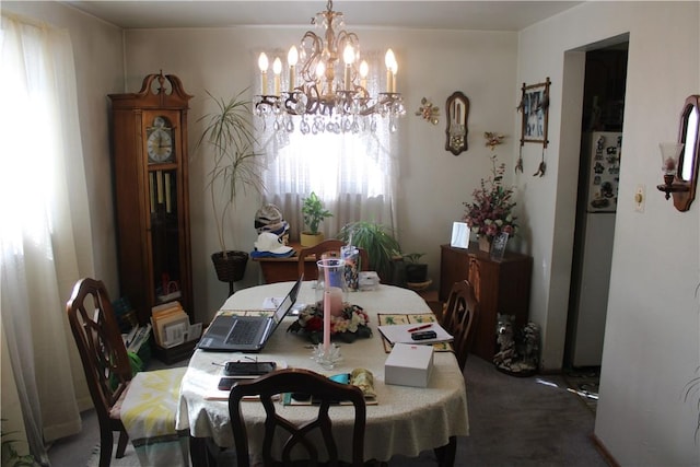 carpeted dining area featuring a chandelier