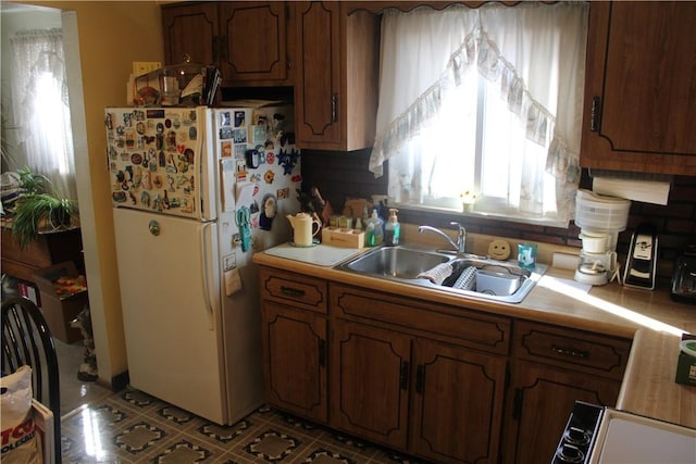 kitchen with white refrigerator and sink