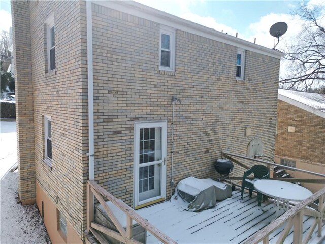 view of snow covered rear of property