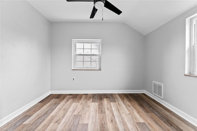 unfurnished room featuring hardwood / wood-style flooring, vaulted ceiling, and ceiling fan