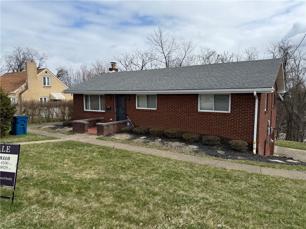 157 Duff Rd, Penn Hills, PA 15235 - view of front facade with brick siding, a shingled roof, a front lawn, and a chimney
