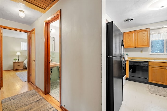 hallway featuring sink and light hardwood / wood-style flooring