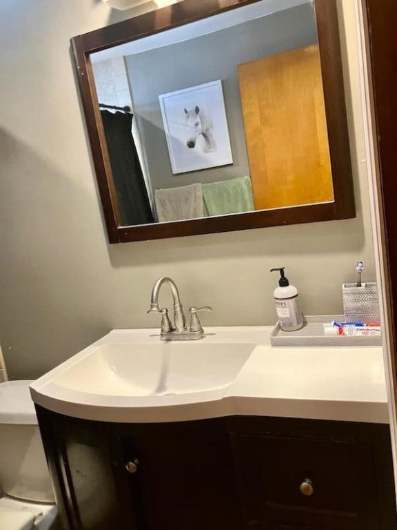 bathroom featuring toilet and vanity