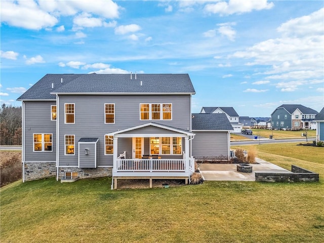 rear view of house with a patio and a lawn