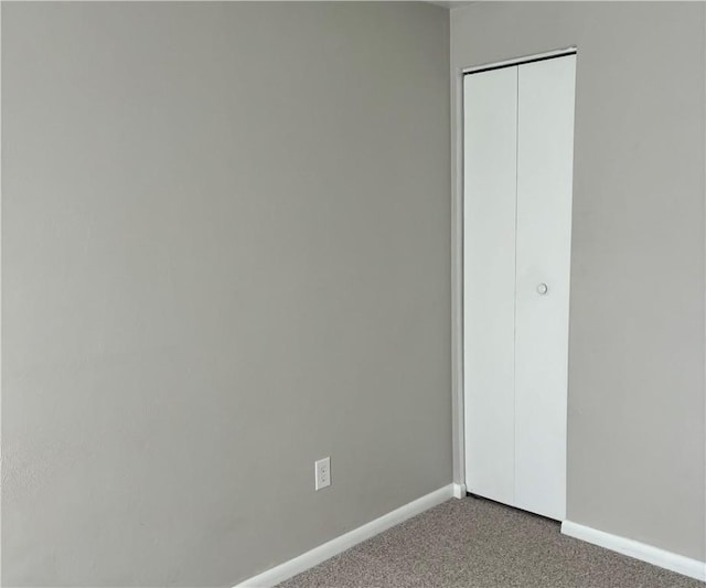 unfurnished bedroom featuring carpet floors and a closet