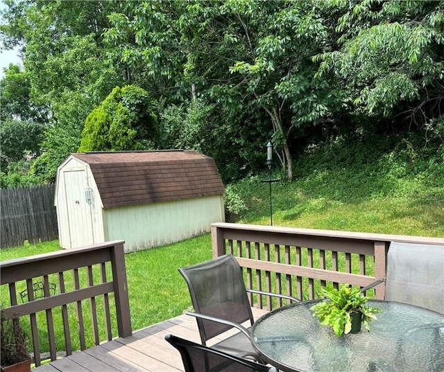 deck with a yard and a storage shed