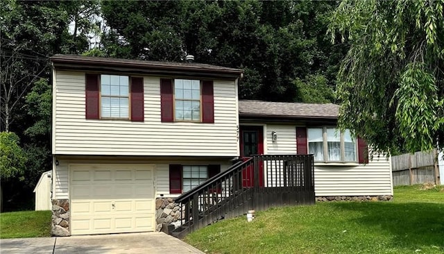 tri-level home with a front lawn and a garage