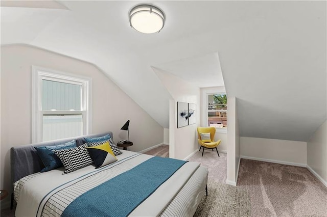 carpeted bedroom featuring lofted ceiling