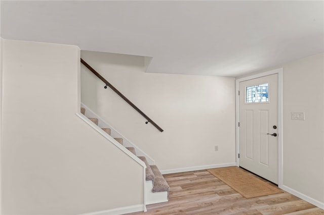 foyer entrance with light hardwood / wood-style floors