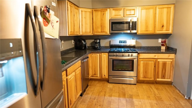 kitchen with appliances with stainless steel finishes and light wood-type flooring