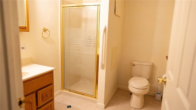 bathroom with tile patterned floors, vanity, toilet, and a shower with door