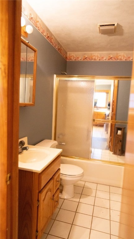 full bathroom with enclosed tub / shower combo, tile patterned floors, toilet, and vanity