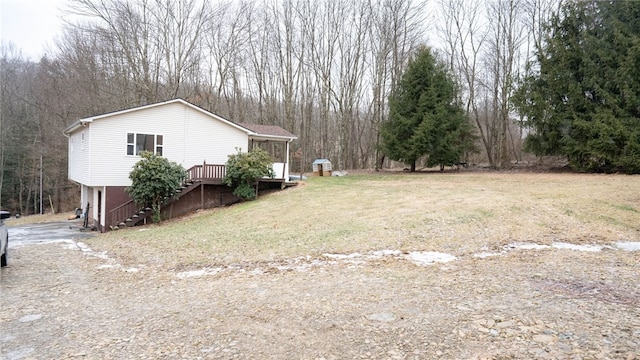 view of yard with a deck and a sunroom