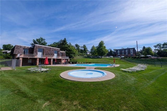 exterior space featuring a pool and a lawn