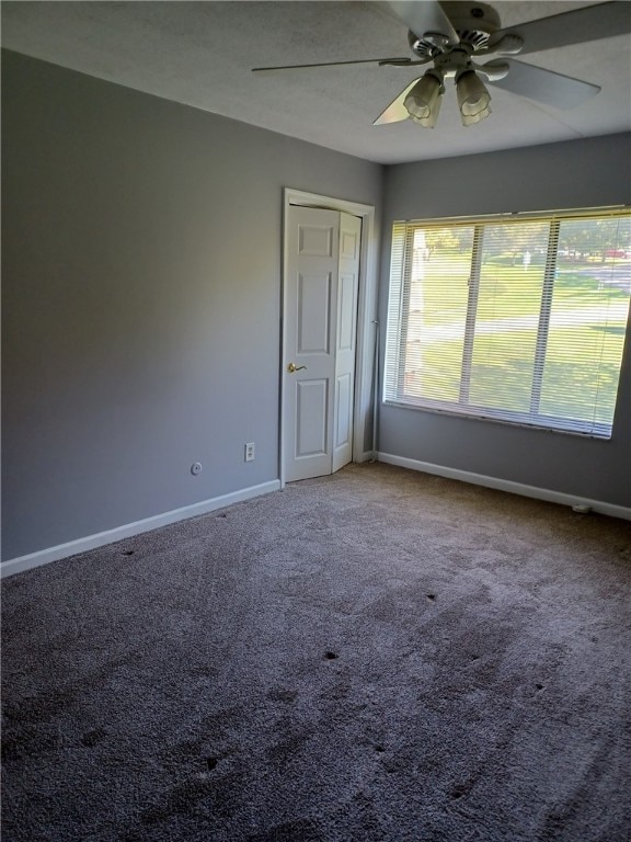 spare room with carpet and ceiling fan