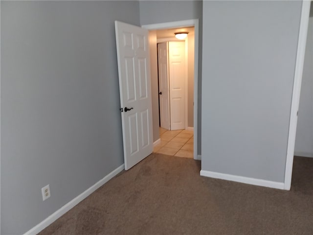 unfurnished bedroom featuring light colored carpet