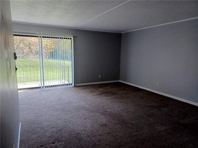 carpeted spare room with a textured ceiling