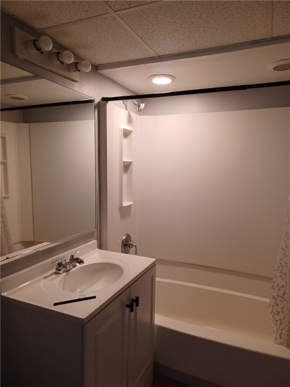 bathroom with shower / bath combination with curtain, vanity, and a drop ceiling