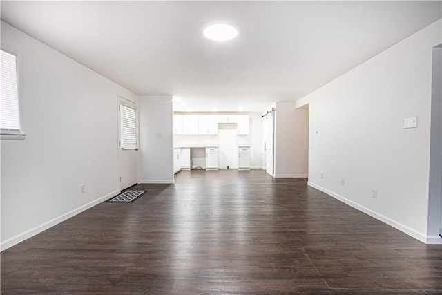 unfurnished living room with dark wood-type flooring