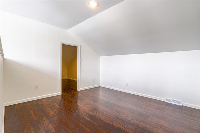 bonus room featuring dark hardwood / wood-style floors and vaulted ceiling