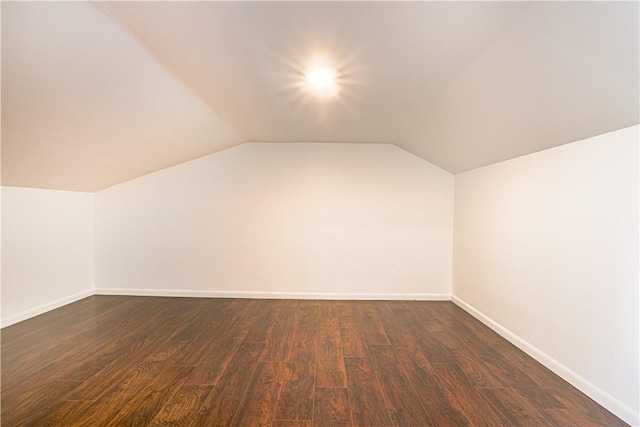 bonus room featuring lofted ceiling and dark hardwood / wood-style flooring