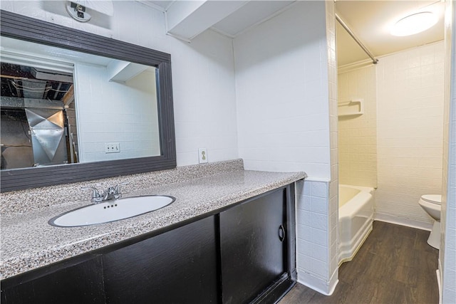 full bathroom featuring vanity, wood-type flooring, shower / washtub combination, and toilet