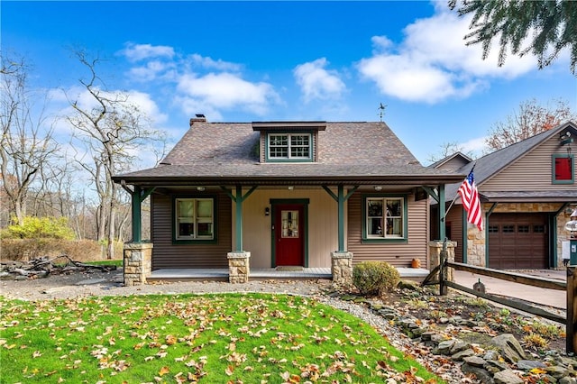 bungalow-style house with a garage, a front yard, and covered porch