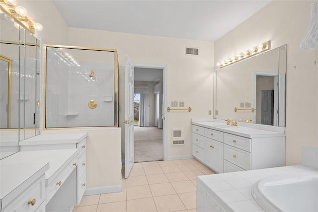 bathroom featuring vanity, independent shower and bath, and tile patterned flooring