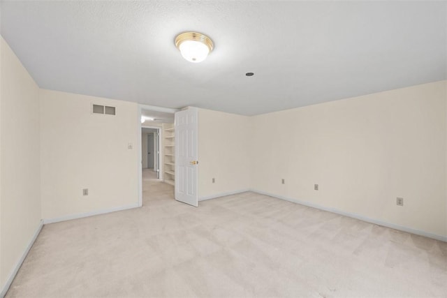 carpeted spare room featuring a textured ceiling