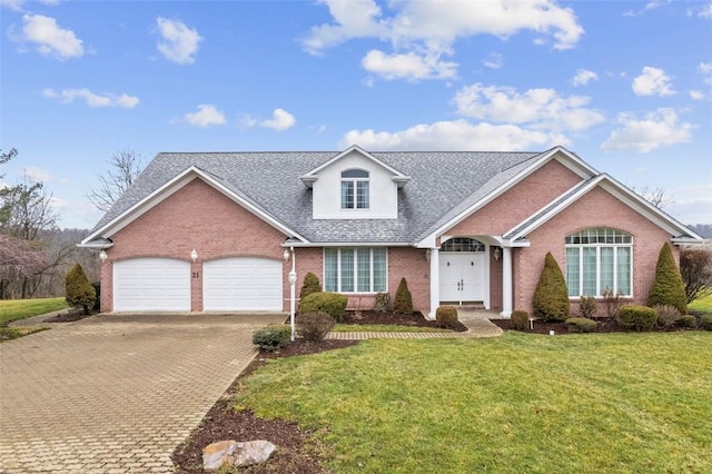 view of front of property featuring a garage and a front yard