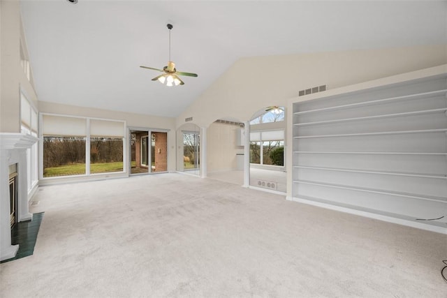 unfurnished living room with high vaulted ceiling, ceiling fan, and carpet flooring