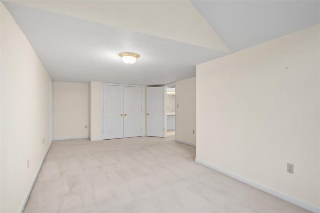 interior space with light carpet and a closet