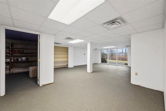 basement featuring a paneled ceiling