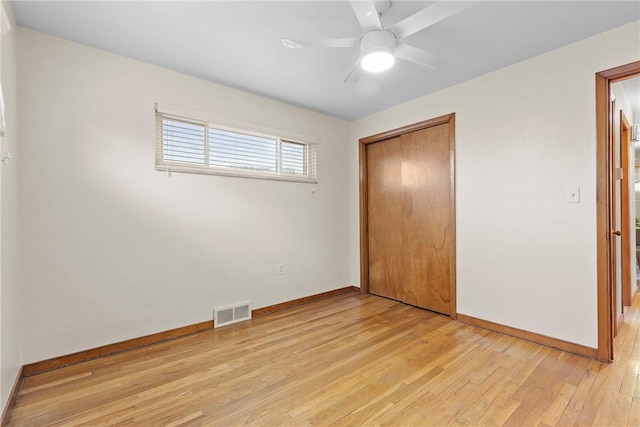 unfurnished bedroom with a closet, ceiling fan, and light wood-type flooring