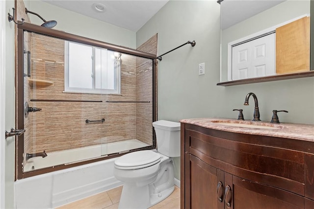 full bathroom featuring vanity, tile patterned floors, enclosed tub / shower combo, and toilet